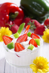 Yogurt with strawberries and sweet pepper. Light breakfast.