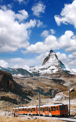 Fototapeta premium Famous Matterhorn peak with a train in Swiss Alps, Switzerland