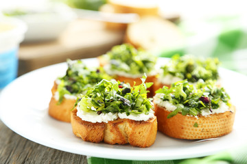 Tasty fresh bruschetta on plate on grey wooden background