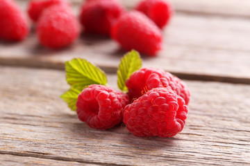 Red raspberries on grey wooden background