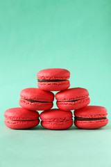 Red macarons on green background