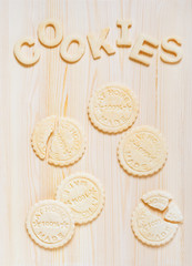 Cookies and letters of shortcrust pastry on the wooden table