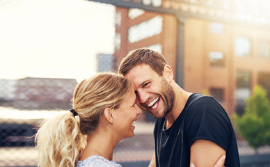 Happy spontaneous couple share a good joke