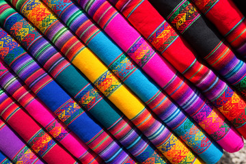 Colorful fabric folded and stacked in a pile