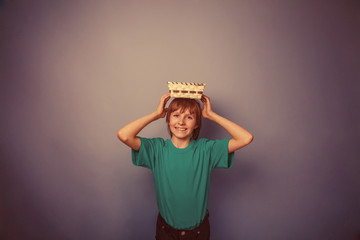 European -looking  boy of ten years holding an empty basket in h