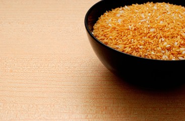 Black Bowl with Yellow Rice,Orange Background