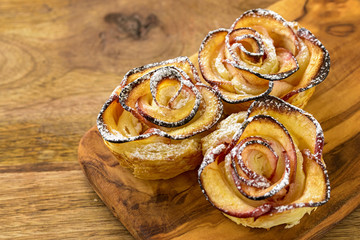 apple shaped rose dessert on wooden table
