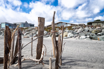 California beach. Miles of white sand. Boulders in the foreground. Houses