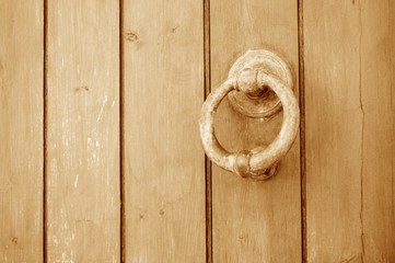 Ancient wooden door with old door knocker