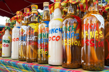 Assortment of rhum bottles at the market - obrazy, fototapety, plakaty