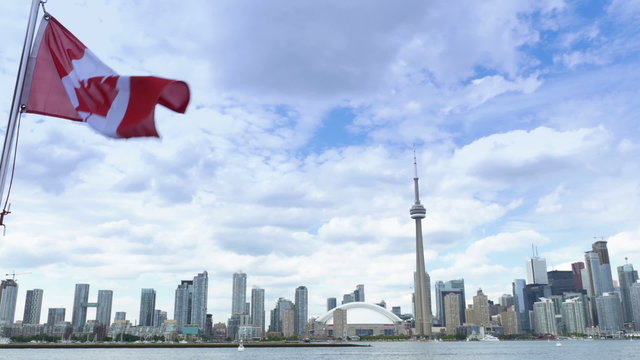4K Toronto Skyline from Lake Ontario with CN Tower and Canadian Flag