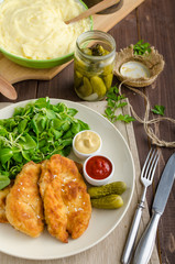 Schnitzel with mashed potatoes and salad