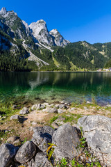 Beautiful landscape of alpine lake with crystal clear green water and mountains in background, Gosausee, Austria