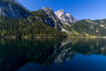 Fototapeta na wymiar Beautiful landscape of alpine lake with crystal clear green water and mountains in background, Gosausee, Austria