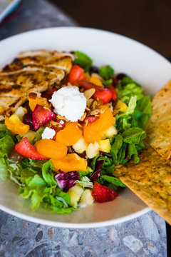 Healthy salad with grilled chicken and fruits