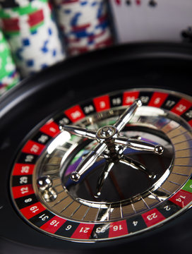 Poker Chips on a gaming with casino roulette