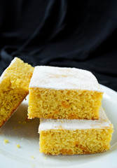 manna cake with candied fruits and coffee on black background