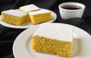 manna cake with candied fruits and coffee on black background