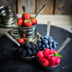 Mix of fresh berries on rustic background