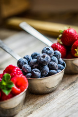 Mix of fresh berries on rustic background