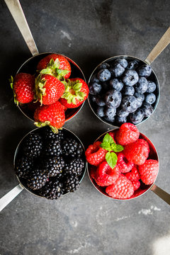 Mix of fresh berries on rustic background