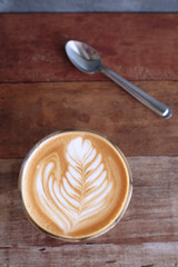 Hot art Latte Coffee in a cup on wooden table