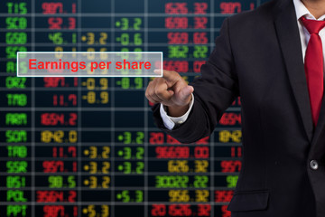 Businessman hand touching Earnings per share sign on virtual scr