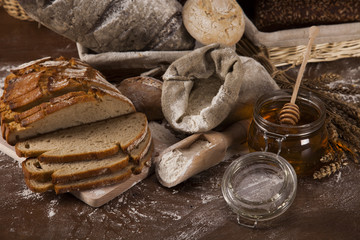 Fototapeta na wymiar Fresh bread and wheat on the wooden