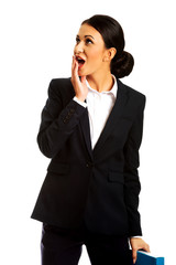 Shocked businesswoman holding a binder