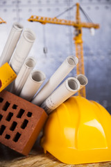 Fototapeta premium Crane, Safety helmet, Blueprints and construction site