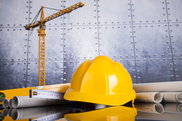Project drawings, building and cranes under construction