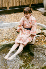 Asian woman wearing yukata in Asian garden