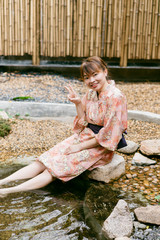 Asian woman wearing yukata in Asian garden