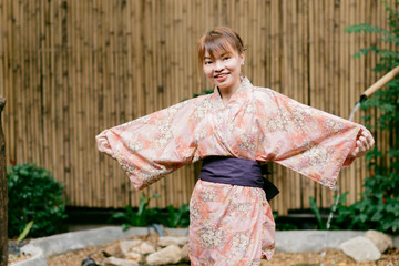 Asian woman wearing yukata in Asian garden