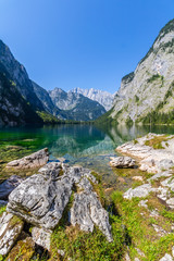 Beautiful landscape of alpine lake with crystal clear green water and mountains in background, Obersee, Germany