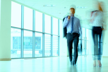 businesspeople walking in the corridor of an business center