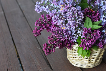 basket with  branch of lilac