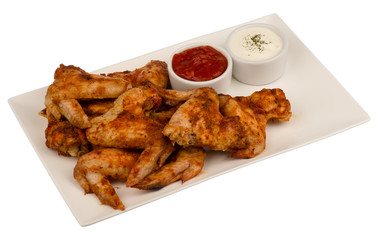 Roasted chicken wings on the white plate isolated.