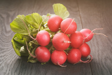 fresh radishes on old wooden table