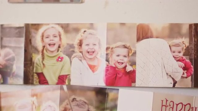 Close up of family photos on a fridge
