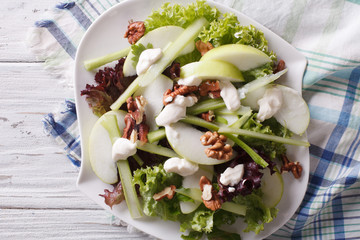 Waldorf Salad with apples, celery and walnuts close-up. horizontal top view
