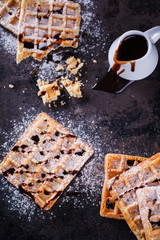 Belgian waffles with powdered sugar and chocolate sauce.selective focus
