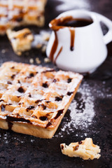 Belgian waffles with powdered sugar and chocolate sauce.selective focus