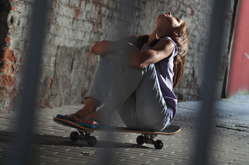 teenage girl with skateboard in the street © Cherry-Merry