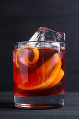 Old fashioned cocktail on the wooden background