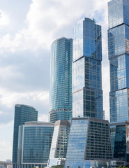 Fototapeta na wymiar High-rise buildings on blue sky, close up view