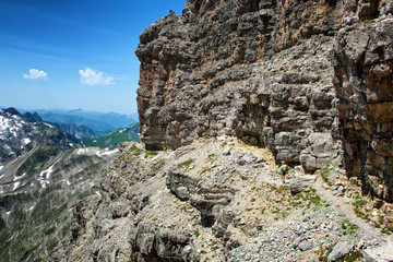 Hiker on a mountain trail in the alps