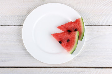 watermelon on a plate on a wooden background