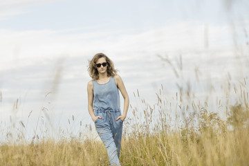 beautiful young woman posing on a meadow. Summer fashion photo. Lifestyle