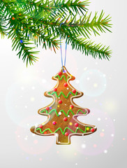 Christmas tree branch with hanging gingerbread cookie